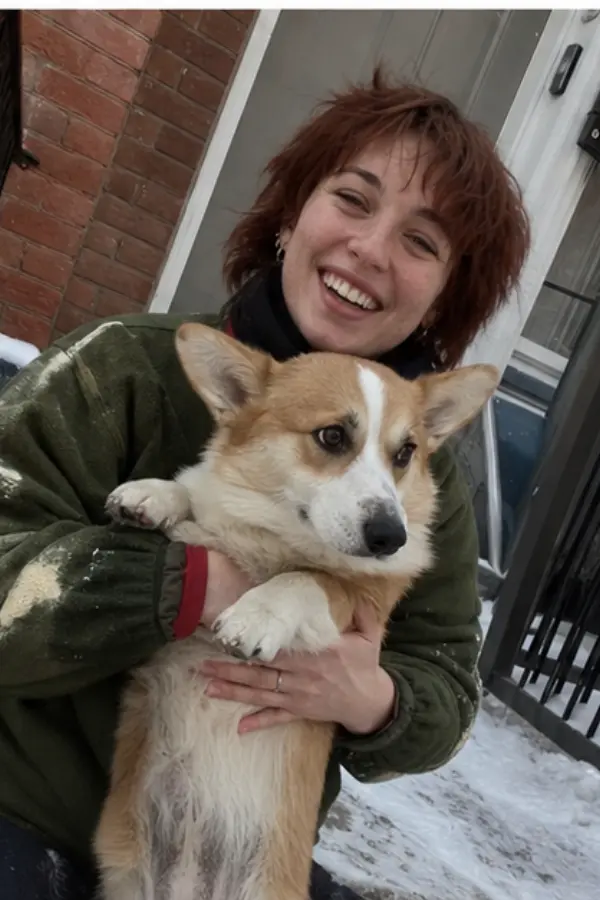 Amélie holding a friend’s corgi