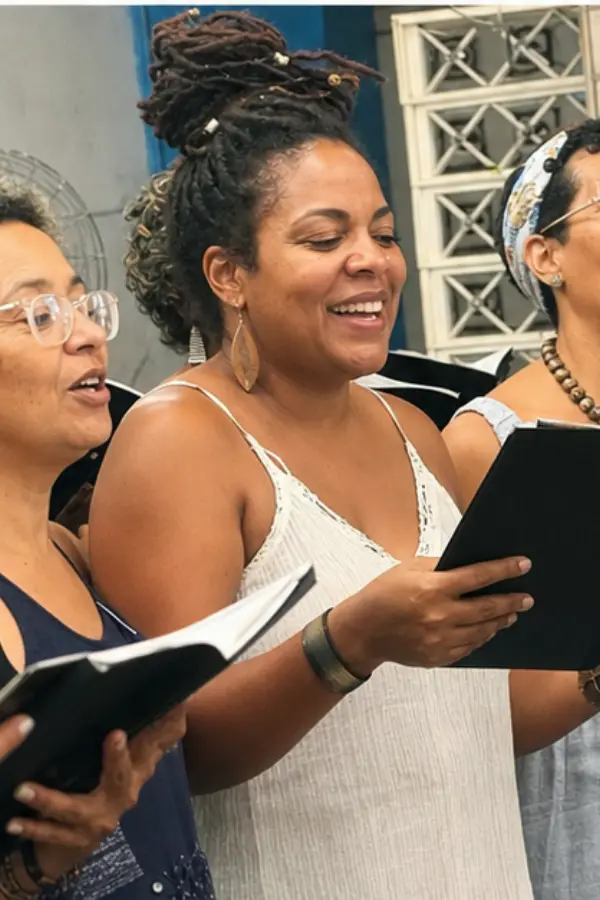Beatriz singing with a small group