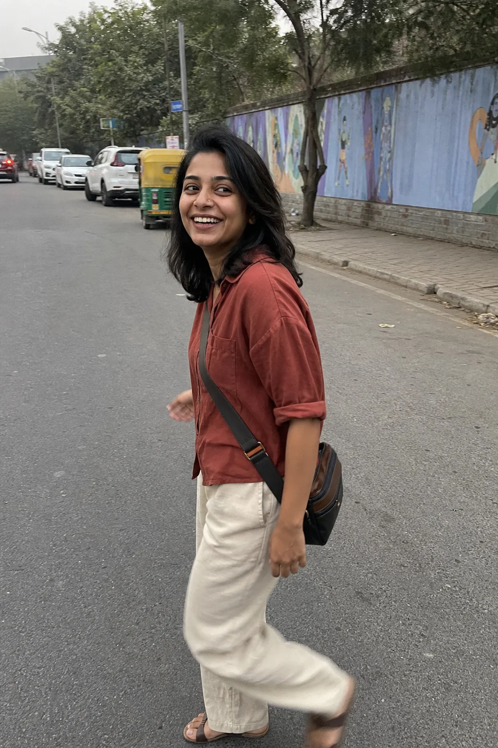 Meera glancing back at a friend on a New Delhi street